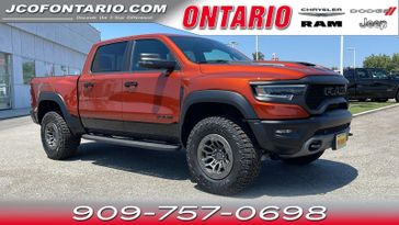 2024 RAM 1500 TRX in a Harvest Sunrise exterior color and Blackinterior. Ontario Auto Center ontarioautocenter.com 