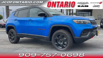 2023 Jeep Compass Trailhawk in a Laser Blue Pearl Coat exterior color and Ruby Red/Blackinterior. Ontario Auto Center ontarioautocenter.com 
