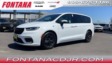 2023 Chrysler Pacifica Plug-in Hybrid Touring L in a Bright White Clear Coat exterior color and Blackinterior. Fontana Chrysler Dodge Jeep RAM (909) 675-1186 fontanacdjr.com 