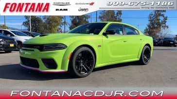 2023 Dodge Charger Scat Pack Widebody in a Sublime exterior color and Blackinterior. Fontana Chrysler Dodge Jeep RAM (909) 675-1186 fontanacdjr.com 