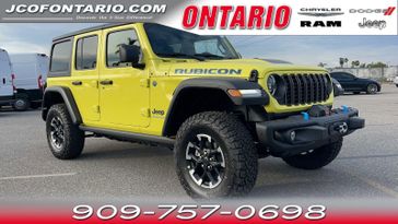 2024 Jeep Wrangler 4xE Rubicon in a High Velocity Clear Coat exterior color and Blackinterior. Ontario Auto Center ontarioautocenter.com 