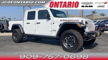 2023 Jeep Gladiator Mojave 4x4 in a Bright White Clear Coat exterior color and Blackinterior. Jeep Chrysler Dodge RAM FIAT of Ontario 909-757-0698 jcofontario.com 