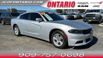 2022 Dodge Charger SXT in a Triple Nickel Clear Coat exterior color and Blackinterior. Jeep Chrysler Dodge RAM FIAT of Ontario 909-757-0698 jcofontario.com 