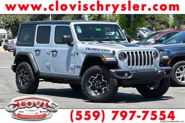 2023 Jeep Wrangler Rubicon 4xe in a Silver Zynith Clear Coat exterior color and Blackinterior. Clovis Chrysler Dodge Jeep RAM 559-314-1399 clovischryslerdodgejeepram.com 