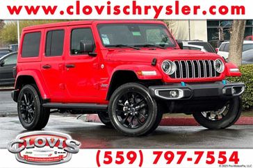 2024 Jeep Wrangler 4-door Sahara 4xe in a Firecracker Red Clear Coat exterior color. Clovis Chrysler Dodge Jeep RAM 559-314-1399 clovischryslerdodgejeepram.com 