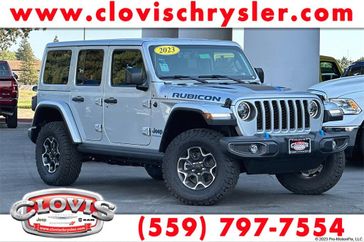 2023 Jeep Wrangler Rubicon 4xe in a Silver Zynith Clear Coat exterior color and Blackinterior. Clovis Chrysler Dodge Jeep RAM 559-314-1399 clovischryslerdodgejeepram.com 