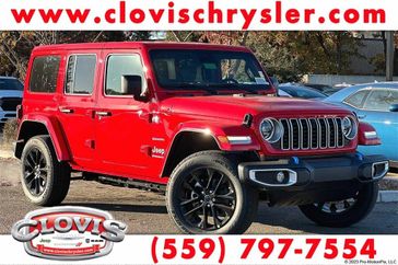 2024 Jeep Wrangler 4-door Sahara 4xe in a Firecracker Red Clear Coat exterior color and Blackinterior. Clovis Chrysler Dodge Jeep RAM 559-314-1399 clovischryslerdodgejeepram.com 