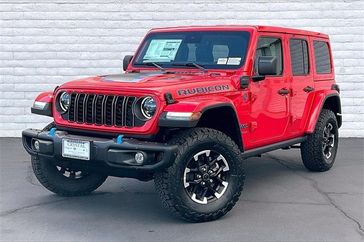 2024 Jeep Wrangler 4-door Rubicon X 4xe in a Firecracker Red Clear Coat exterior color and Blackinterior. Crystal Chrysler Jeep Dodge Ram (760) 507-2975 pixelmotiondemo.com 