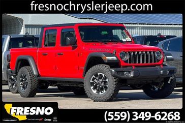 2024 Jeep Gladiator Rubicon 4x4 in a Firecracker Red Clear Coat exterior color. Fresno Chrysler Dodge Jeep RAM 559-206-5254 fresnochryslerjeep.com 