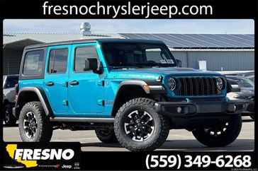 2024 Jeep Wrangler 4-door Rubicon 4xe in a Bikini Pearl Coat exterior color. Fresno Chrysler Dodge Jeep RAM 559-206-5254 fresnochryslerjeep.com 