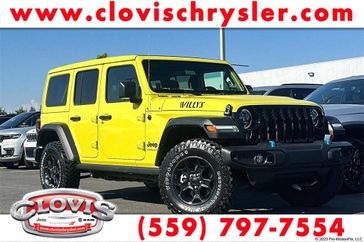 2023 Jeep Wrangler Willys 4xe in a High Velocity Clear Coat exterior color and Blackinterior. Clovis Chrysler Dodge Jeep RAM 559-314-1399 clovischryslerdodgejeepram.com 