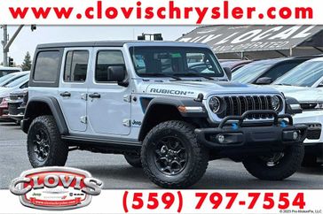 2023 Jeep Wrangler Rubicon 4xe in a Silver Zynith Clear Coat exterior color and Red/Blackinterior. Clovis Chrysler Dodge Jeep RAM 559-314-1399 clovischryslerdodgejeepram.com 