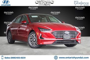 2023 Hyundai Sonata Hybrid Limited in a Ultimate Red exterior color and Dark Gray/Camelinterior. Ontario Auto Center ontarioautocenter.com 