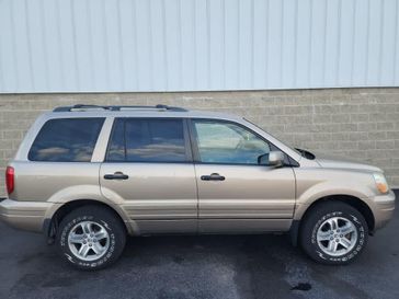 2004 Honda Pilot EX in a Sandstone Metallic exterior color and Saddleinterior. Wilmington Auto Center Chrysler Dodge Jeep Ram (937) 556-6430 wilmingtonautocentercdjr.com 