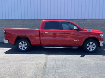 2022 RAM 1500 Laramie 4x4 Crew Cab 64 Box in a Flame Red Clear Coat exterior color and Blackinterior. Wilmington Auto Center Chrysler Dodge Jeep Ram (937) 556-6430 wilmingtonautocentercdjr.com 