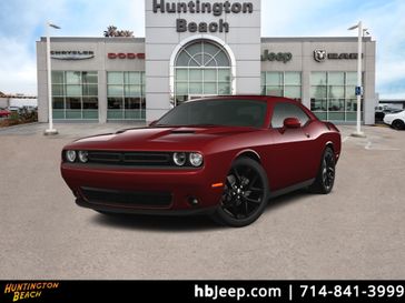 2023 Dodge Challenger SXT in a Octane Red Pearl Coat exterior color and Blackinterior. BEACH BLVD OF CARS beachblvdofcars.com 