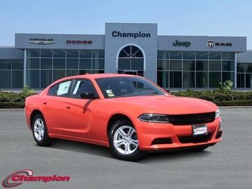 2023 Dodge Charger SXT Rwd in a Go Mango exterior color and HOUNDSTOOTHinterior. Champion Chrysler Jeep Dodge Ram 800-549-1084 pixelmotiondemo.com 