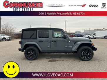 2024 Jeep Wrangler 4xE Sahara in a Anvil Clear Coat exterior color and Blackinterior. Cornhusker Auto Center 402-866-8665 cornhuskerautocenter.com 