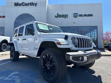 2024 Jeep Wrangler 4-door Sahara 4xe in a Bright White Clear Coat exterior color. McCarthy Jeep Ram 816-434-0674 mccarthyjeepram.com 