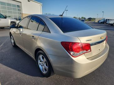 2014 Chevrolet Cruze 1LT in a Champagne Silver Metallic exterior color and Jet Blackinterior. Wilmington Auto Center Chrysler Dodge Jeep Ram (937) 556-6430 wilmingtonautocentercdjr.com 