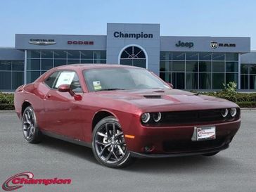 2023 Dodge Challenger SXT in a Octane Red exterior color and NAPPA LEATHERinterior. Champion Chrysler Jeep Dodge Ram 800-549-1084 pixelmotiondemo.com 