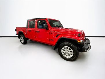 2023 Jeep Gladiator Sport S 4x4 in a Firecracker Red Clear Coat exterior color and Blackinterior. Sheridan Motors CDJR 307-218-2217 sheridanmotor.com 