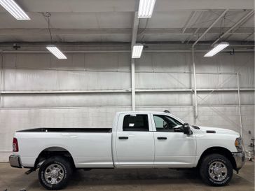 2024 RAM 2500 Tradesman Crew Cab 4x4 8' Box in a Bright White Clear Coat exterior color and Diesel Gray/Blackinterior. Wilmington Auto Center Chrysler Dodge Jeep Ram (937) 556-4751 wilmingtonautocentercdjr.com 