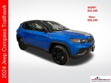 2024 Jeep Compass Trailhawk 4x4 in a Laser Blue Pearl Coat exterior color and Ruby Red/Blackinterior. Sheridan Motors CDJR 307-218-2217 sheridanmotor.com 