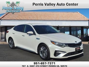 2020 Kia Optima Hybrid EX in a Snow White Pearl exterior color and Blackinterior. Perris Valley Chrysler Dodge Jeep Ram 951-355-1970 perrisvalleydodgejeepchrysler.com 