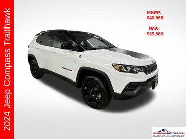 2024 Jeep Compass Trailhawk 4x4 in a Bright White Clear Coat exterior color and Ruby Red/Blackinterior. Sheridan Motors CDJR 307-218-2217 sheridanmotor.com 