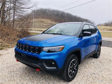 2024 Jeep Compass Trailhawk 4x4 in a Laser Blue Pearl Coat exterior color and Ruby Red/Blackinterior. Mark Porter Chrysler Dodge Jeep Ram (740) 508-5115 markportercdjr.net 