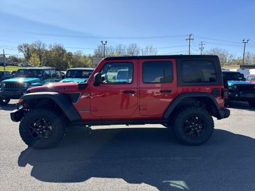 2023 Jeep Wrangler Rubicon 4xe in a Firecracker Red Clear Coat exterior color and Red/Blackinterior. Victor Chrysler Dodge Jeep Ram 585-236-4391 victorcdjr.com 