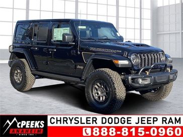 2023 Jeep Wrangler 4-door Rubicon 392 in a Black Clear Coat exterior color and Red/Blackinterior. McPeek's Chrysler Dodge Jeep Ram of Anaheim 888-861-6929 mcpeeksdodgeanaheim.com 