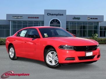 2023 Dodge Charger SXT Rwd in a TorRed exterior color and HOUNDSTOOTHinterior. Champion Chrysler Jeep Dodge Ram 800-549-1084 pixelmotiondemo.com 