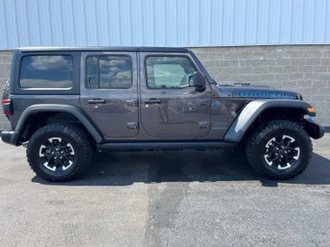 2024 Jeep Wrangler 4xE Rubicon in a Granite Crystal Metallic Clear Coat exterior color and Blackinterior. Wilmington Auto Center Chrysler Dodge Jeep Ram (937) 556-6430 wilmingtonautocentercdjr.com 