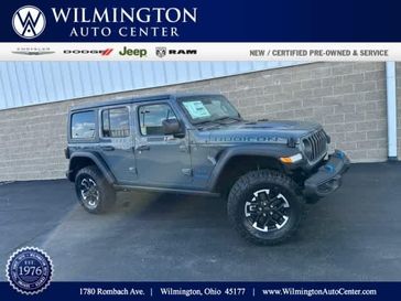 2024 Jeep Wrangler 4-door Rubicon 4xe in a Anvil Clear Coat exterior color and Blackinterior. Wilmington Auto Center Chrysler Dodge Jeep Ram (937) 556-6430 wilmingtonautocentercdjr.com 