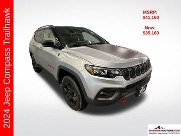 2024 Jeep Compass Trailhawk 4x4 in a Black Clear Coat exterior color and Ruby Red/Blackinterior. Sheridan Motors CDJR 307-218-2217 sheridanmotor.com 