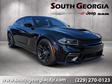 2023 Dodge Charger Scat Pack Widebody in a Pitch Black exterior color and Ruby Red/Blackinterior. South Georgia CDJR 229-443-1466 southgeorgiacdjr.com 