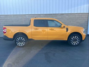 2023 Ford Maverick Lariat FWD SuperCrew in a Cyber Orange Metallic Tri Coat exterior color and Desert Browninterior. Wilmington Auto Center Chrysler Dodge Jeep Ram (937) 556-6430 wilmingtonautocentercdjr.com 