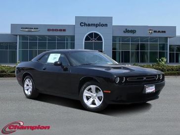2023 Dodge Challenger SXT in a Pitch-Black exterior color and HOUNDSTOOTH CLOinterior. Champion Chrysler Jeep Dodge Ram 800-549-1084 pixelmotiondemo.com 