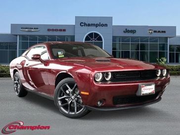 2023 Dodge Challenger SXT in a Octane Red exterior color and HOUNDSTOOTHinterior. Champion Chrysler Jeep Dodge Ram 800-549-1084 pixelmotiondemo.com 