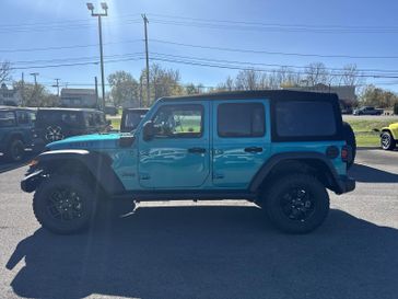 2024 Jeep Wrangler 4-door Willys 4xe in a Bikini Pearl Coat exterior color and Blackinterior. Victor Chrysler Dodge Jeep Ram 585-236-4391 victorcdjr.com 