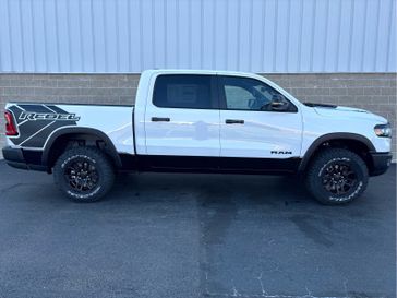 2025 RAM 1500 Rebel Crew Cab 4x4 5'7' Box in a Bright White Clear Coat exterior color and Blackinterior. Wilmington Auto Center Chrysler Dodge Jeep Ram (937) 556-6430 wilmingtonautocentercdjr.com 