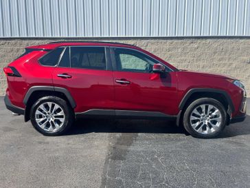 2021 Toyota RAV4 Limited in a Ruby Flare Pearl exterior color and Blackinterior. Wilmington Auto Center Chrysler Dodge Jeep Ram (937) 556-6430 wilmingtonautocentercdjr.com 