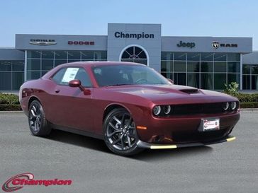 2023 Dodge Challenger Gt in a Octane Red exterior color and HOUNDSTOOTHinterior. Champion Chrysler Jeep Dodge Ram 800-549-1084 pixelmotiondemo.com 