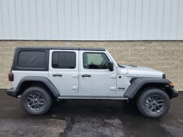 2024 Jeep Wrangler 4-door Sport S in a Silver Zynith Clear Coat exterior color and Blackinterior. Wilmington Auto Center Chrysler Dodge Jeep Ram (937) 556-6430 wilmingtonautocentercdjr.com 