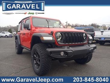 2024 Jeep Wrangler 4-door Willys in a Firecracker Red Clear Coat exterior color and Blackinterior. Garavel Jeep 475-258-7987 norwalkjeep.com 