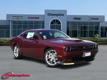 2023 Dodge Challenger Gt in a Octane Red exterior color and HOUNDSTOOTHinterior. Champion Chrysler Jeep Dodge Ram 800-549-1084 pixelmotiondemo.com 