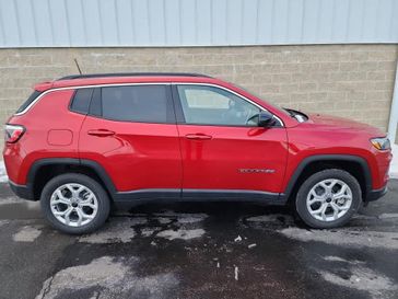 2025 Jeep Compass Latitude 4x4 in a Red Hot Pearl Coat exterior color. Wilmington Auto Center Chrysler Dodge Jeep Ram (937) 556-6430 wilmingtonautocentercdjr.com 