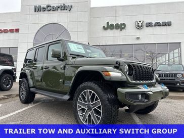 2024 Jeep Wrangler 4-door High Altitude 4xe in a Sarge Green Clear Coat exterior color. McCarthy Jeep Ram 816-434-0674 mccarthyjeepram.com 